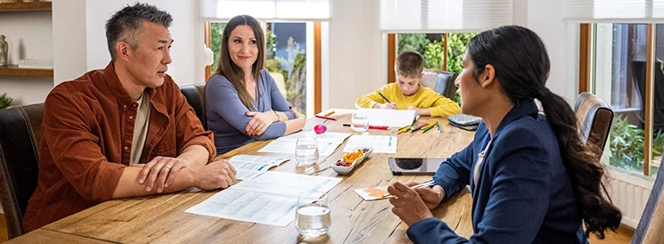 Family of three discussing retirement options with advisor