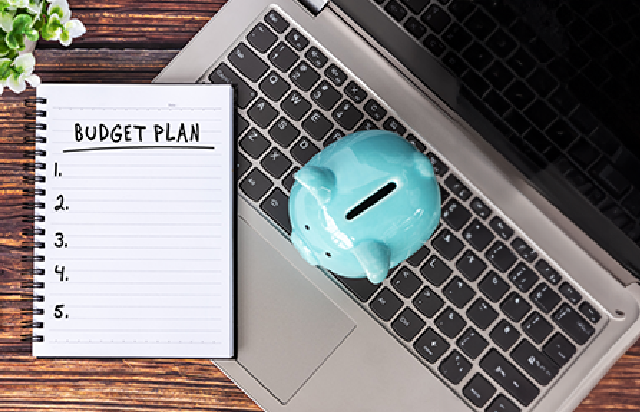 Laptop, piggy bank and budget