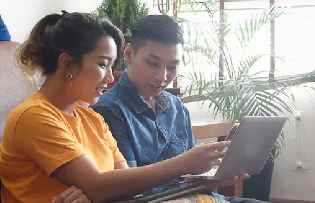 Couple looking at mortgage options on laptop