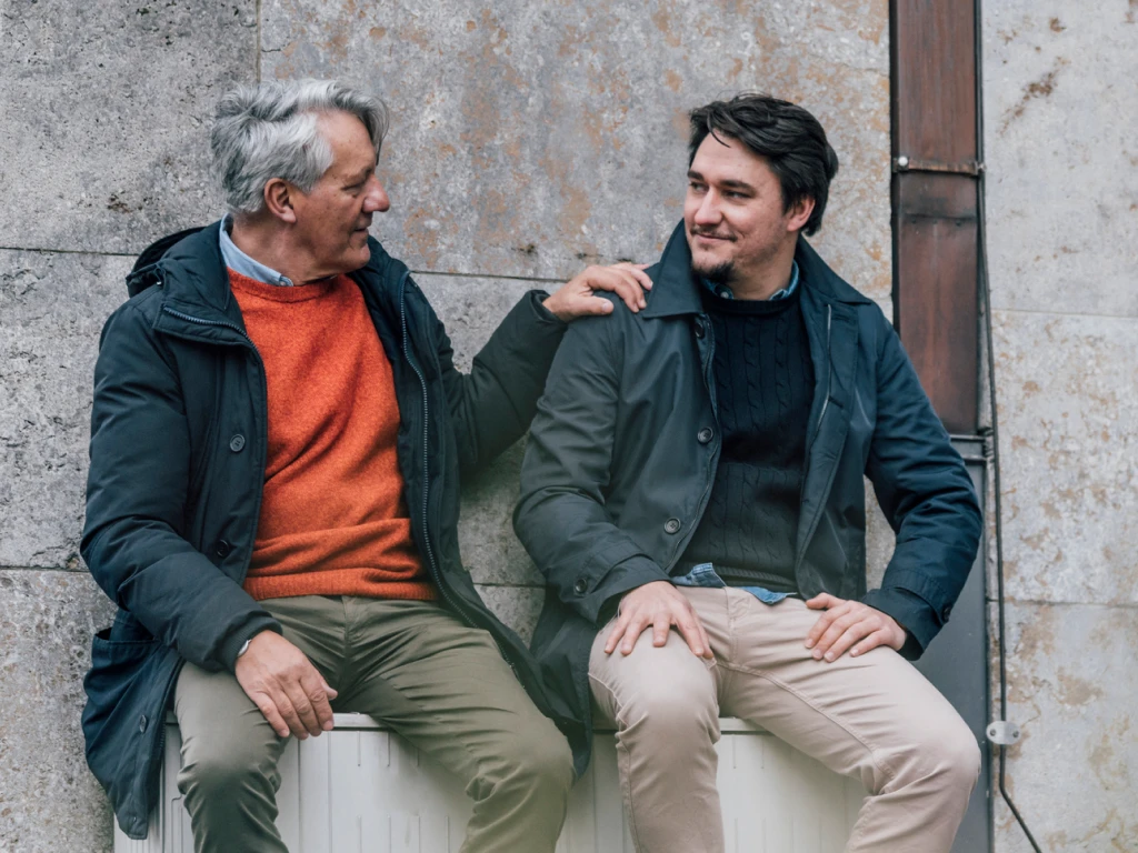 Father and Son Sitting Together on Bench