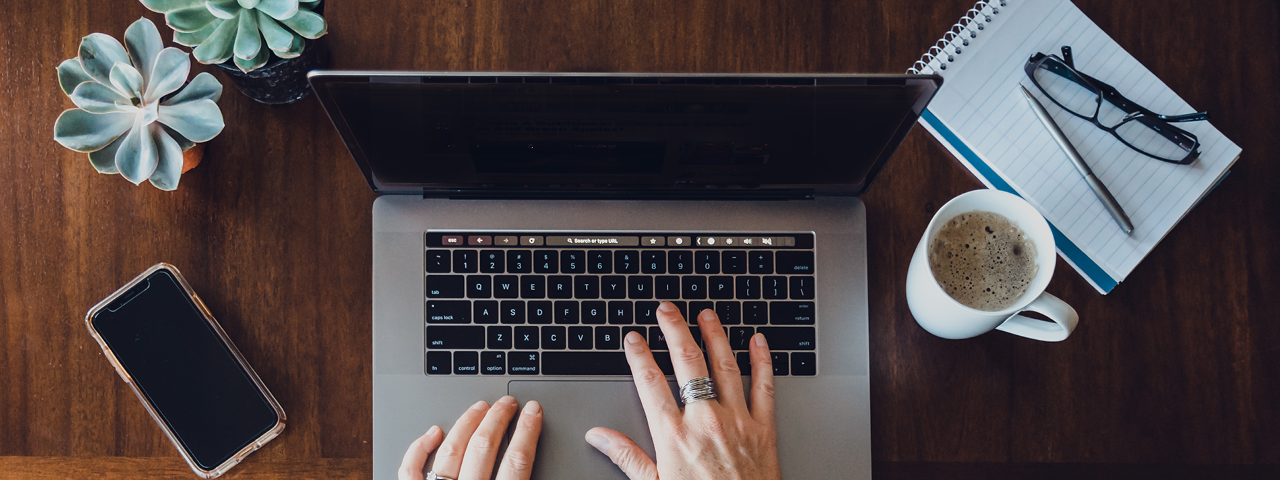 Person Typing on Laptop at Desk