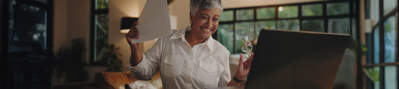 Woman celebrating getting cashback after transferring wealth portfolio