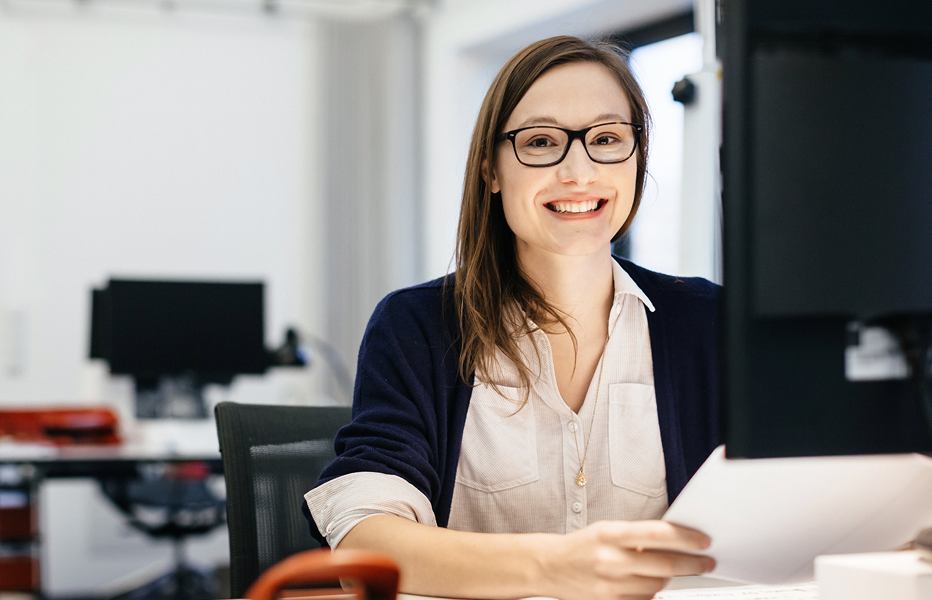 Person Smiling while Sitting at Computer Desk