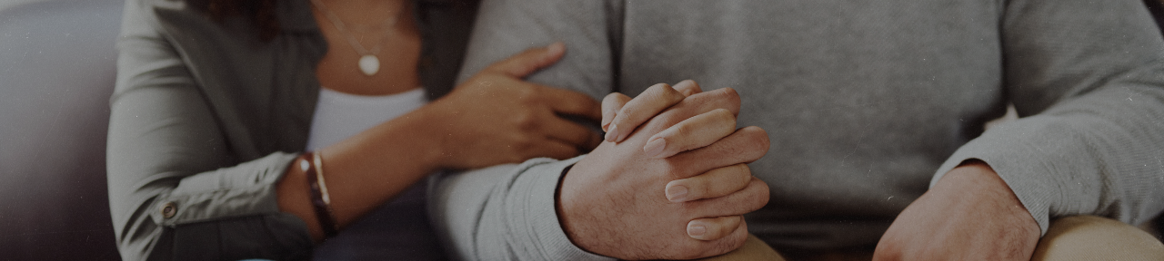 Couple with arms intertwined holding hands