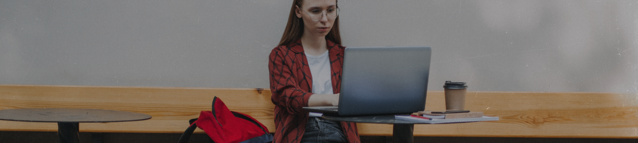 Young woman working on school work on laptop