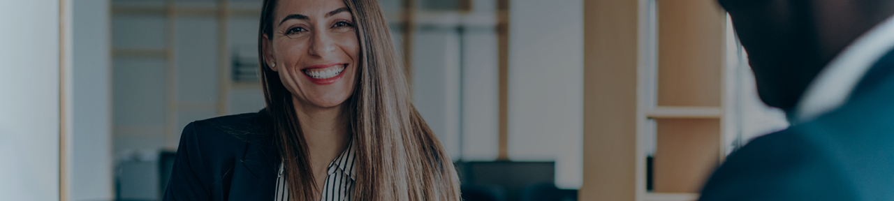 Financial Advisor Smiling While Meeting with Client