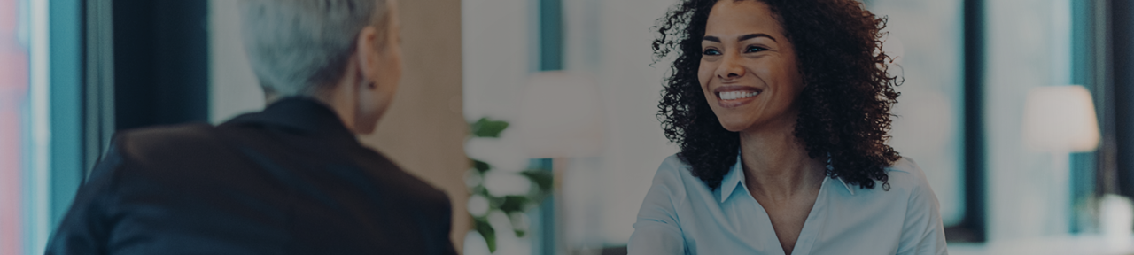 Woman Smiling While Meeting with Financial Advisor