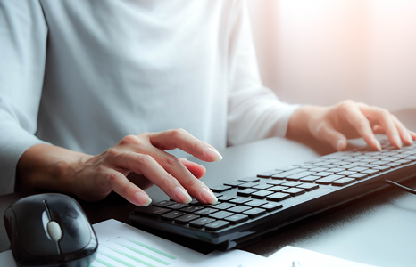 Person Typing on Computer Keyboard