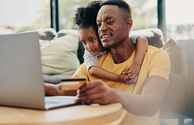Father and Daughter opening FirstOntario account on laptop