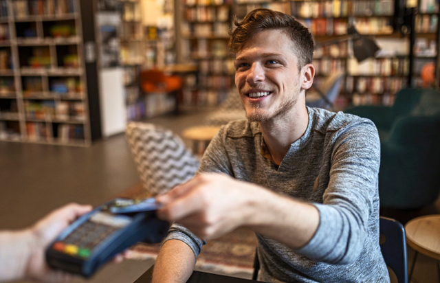 Student Using Credit Card at Bookstore