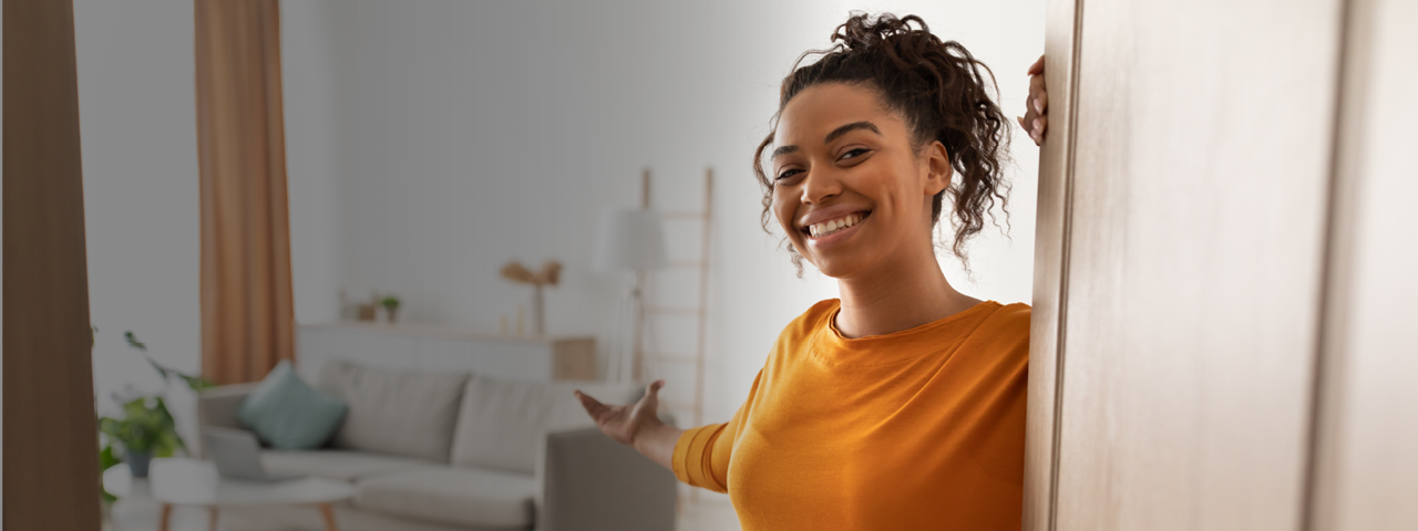 Woman Welcoming Guest to New Home