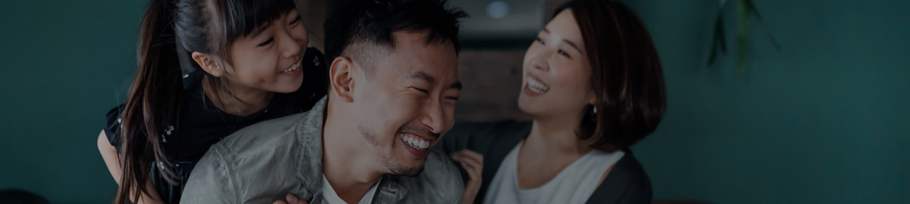 Family of Three Smiling and Embracing 