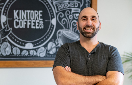 Owner of Kintore Coffee Standing in Coffee Shop