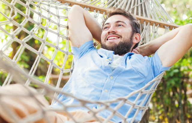 Person Relaxing in Hammock on Sunny Day