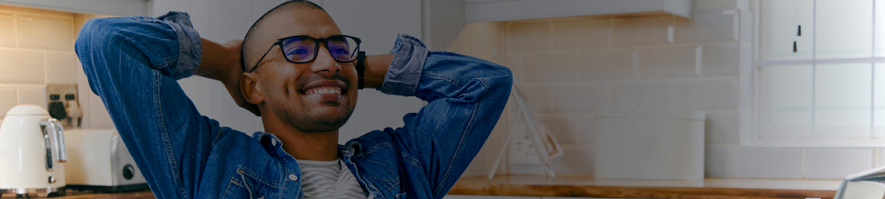 Man Smiling and Relaxing in Kitchen