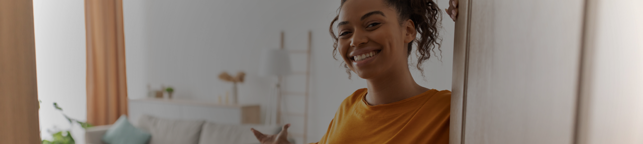 Person Smiling Welcoming Someone Into Their New Home