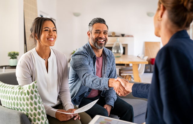 Couple Shaking Financial Advisors Hands