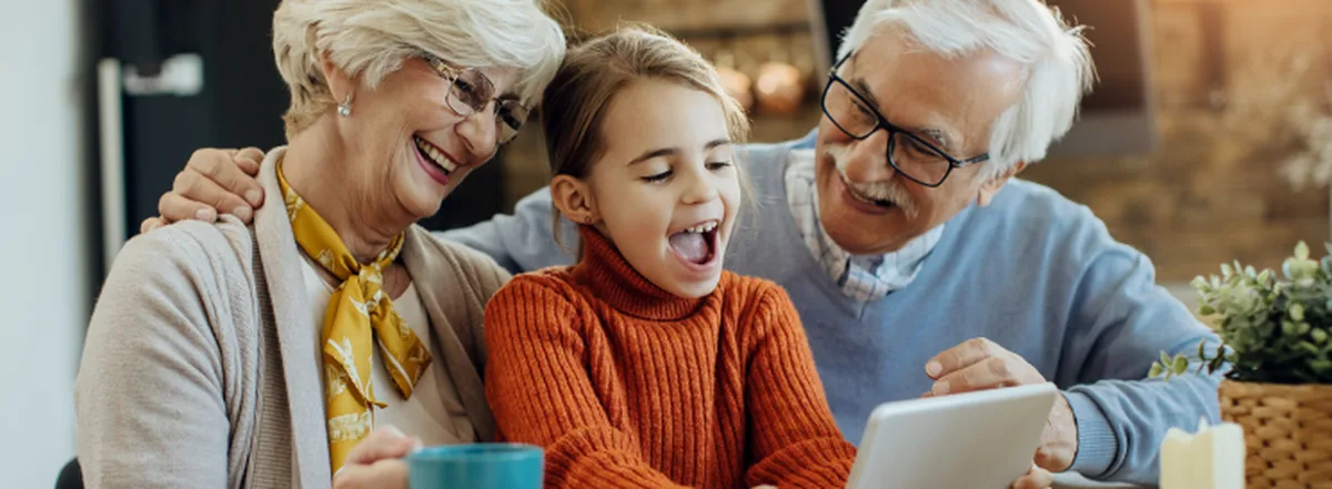 Grandparents smiling and laughing with grandchild