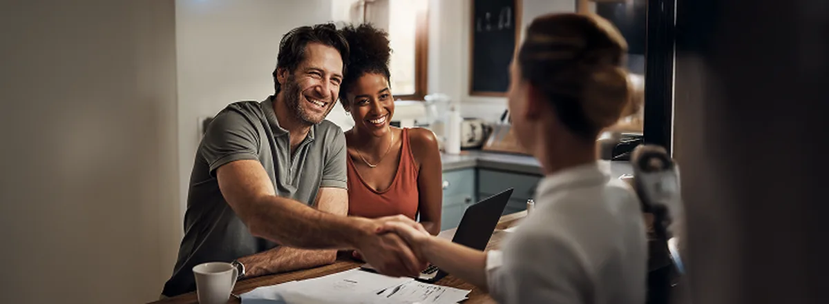 Couple meeting with financial advisor over coffee