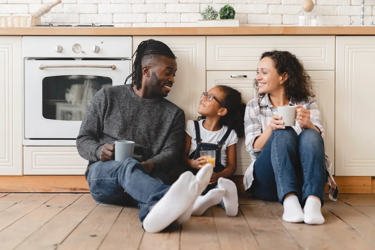 Family enjoying breakfast together at home, feeling relaxed and secure.