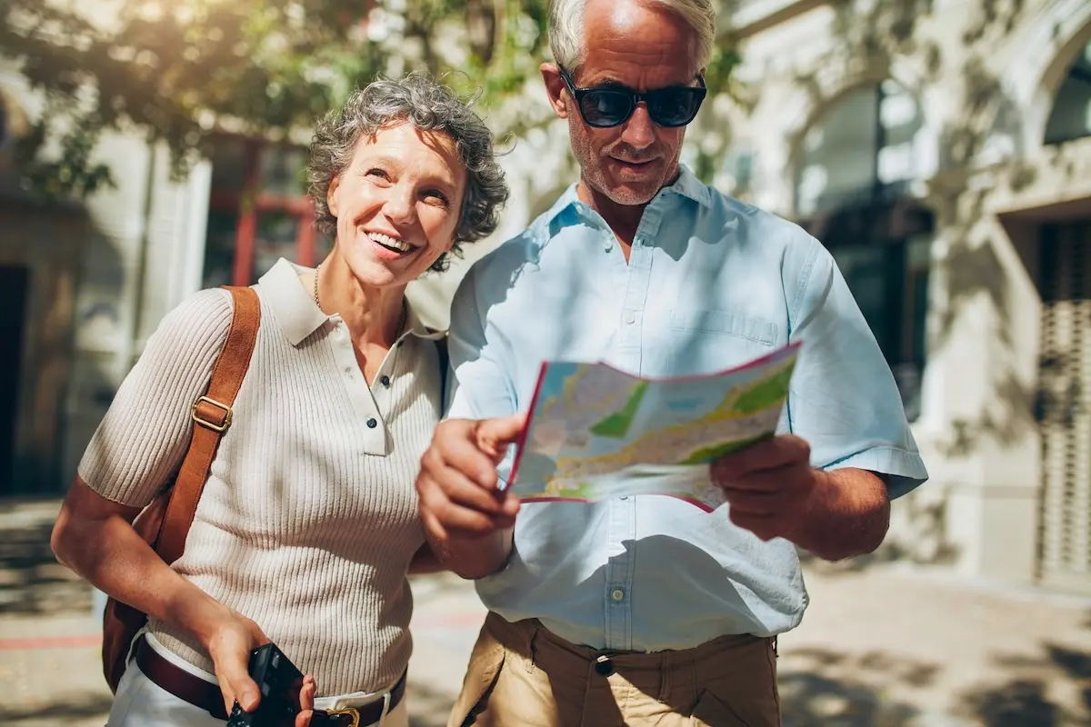 Mature man and woman using map while sightseeing.