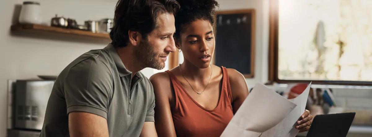 Couple reviewing tax documents while filing their tax return