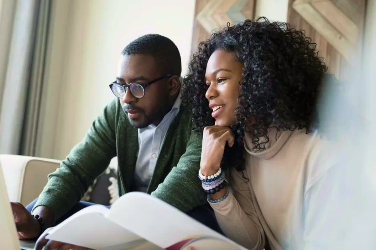 A couple planning their retirement finances on a laptop.