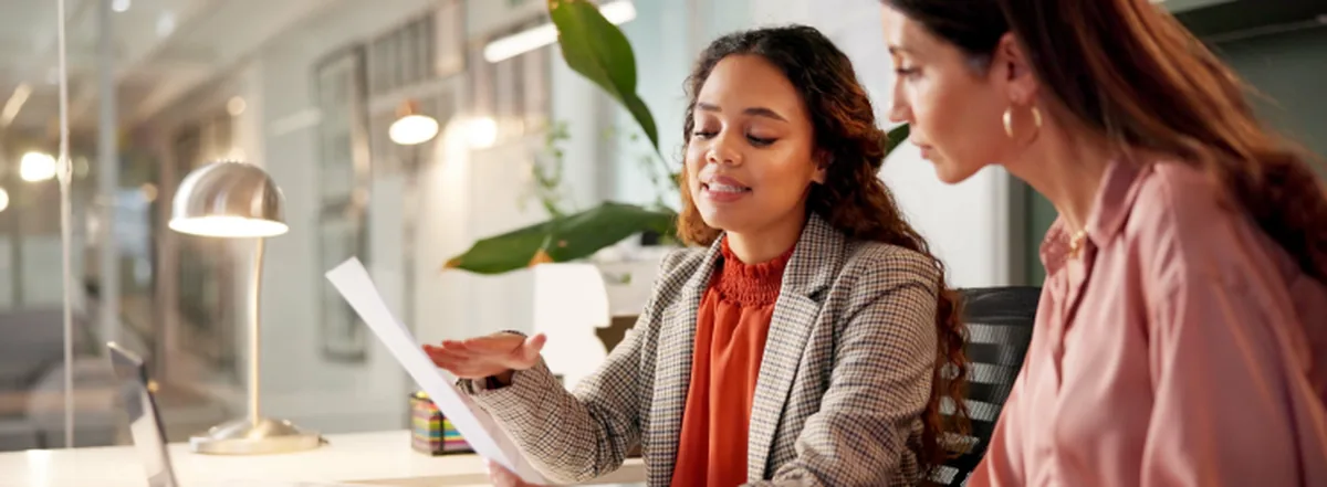 Two women collaborating on report