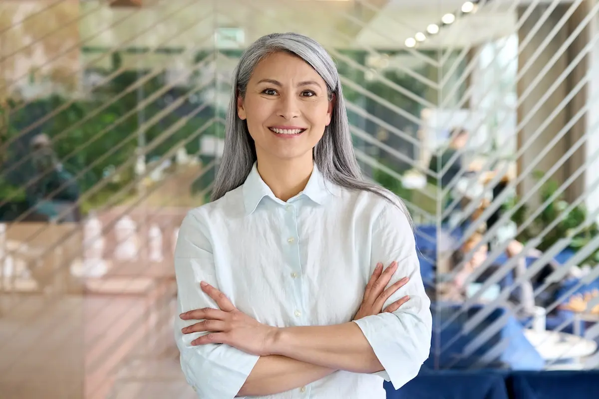 Happy confident business owner standing in a modern office.
