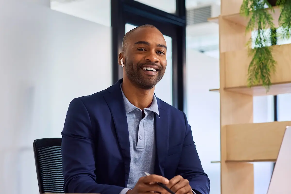 Smiling man works in a bright modern office.