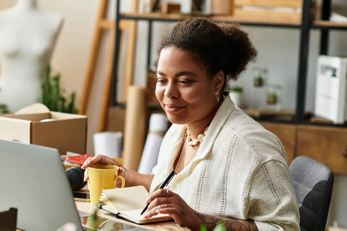 Business owner working on a laptop in her creative studio.