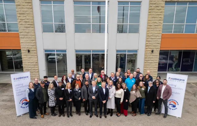 FirstOntario Blue Wave volunteers holding 2025 cheque donation to food banks.
