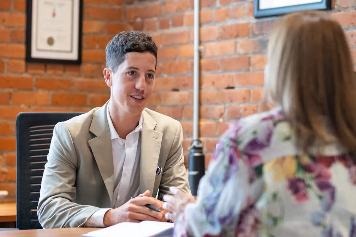 Business advisor meeting with a client in an office, discussing financing options.