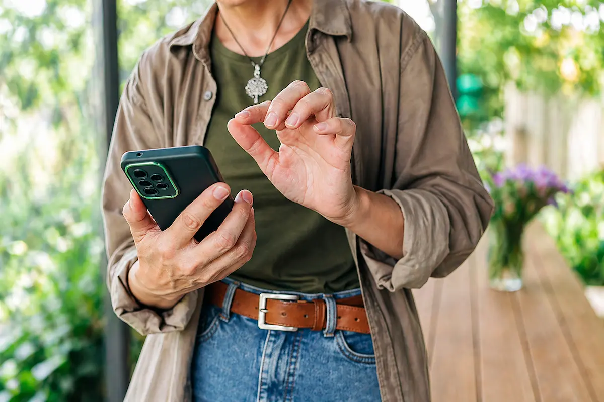 Person using a smartphone to access a mobile banking app with secure login.