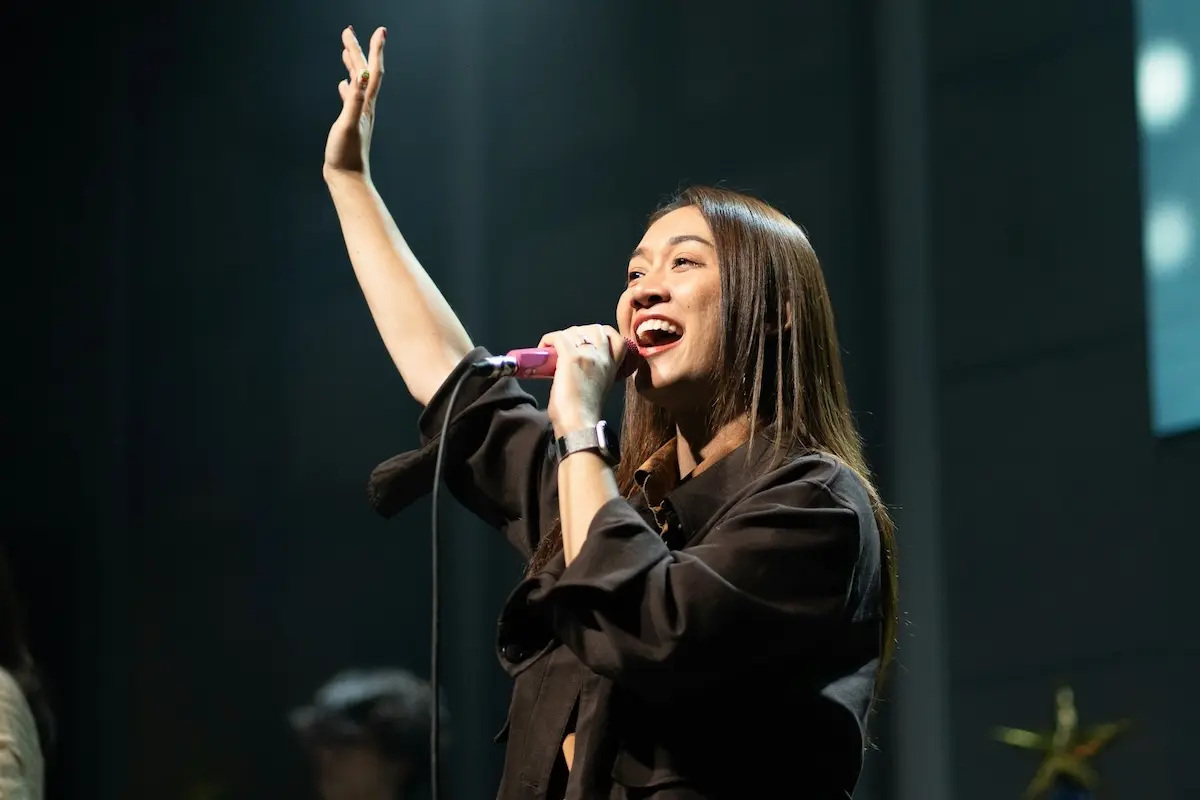 Supporting community, creativity, and connection through the FirstOntario Performing Arts Centre. Performer singing on stage at the FirstOntario Performing Arts Centre.
