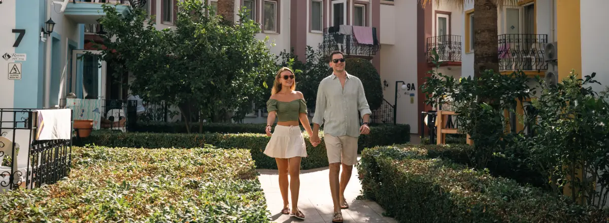 Couple walking through garden on vacation