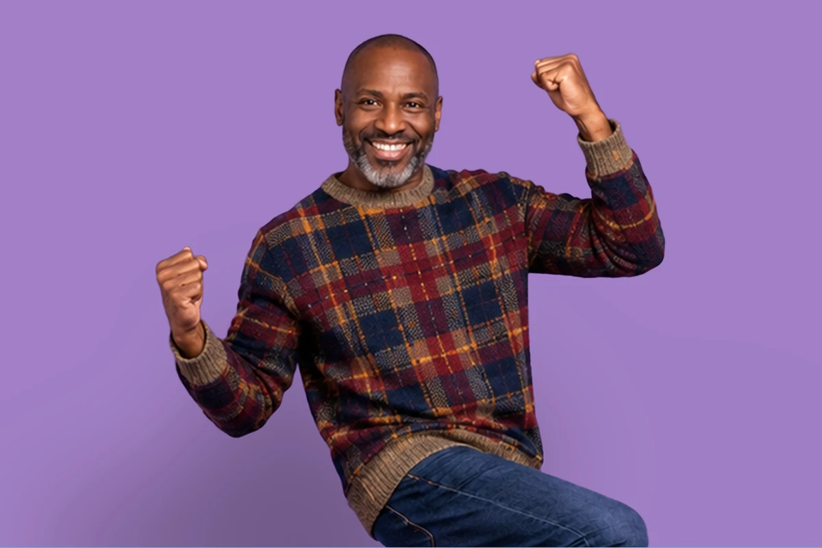 Man in plaid sweater celebrating after earning a cash bonus with FirstOntario Investments. Man in plaid sweater celebrating after earning a cash bonus with FirstOntario Investments.