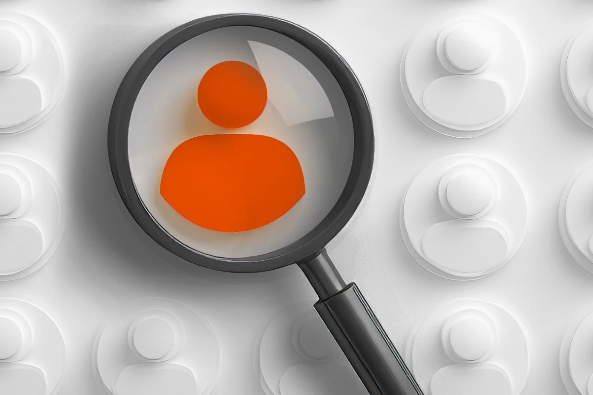 Magnifying glass over orange figure Magnifying glass over orange figure